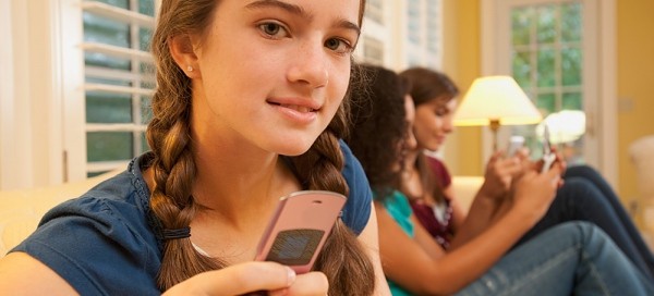 Young Girl Using a Cell Phone with a Contract and parent permission